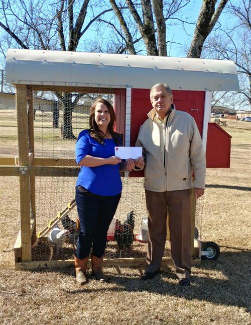 HKS Teacher stands with Steve Hurst in front of chicken coop.